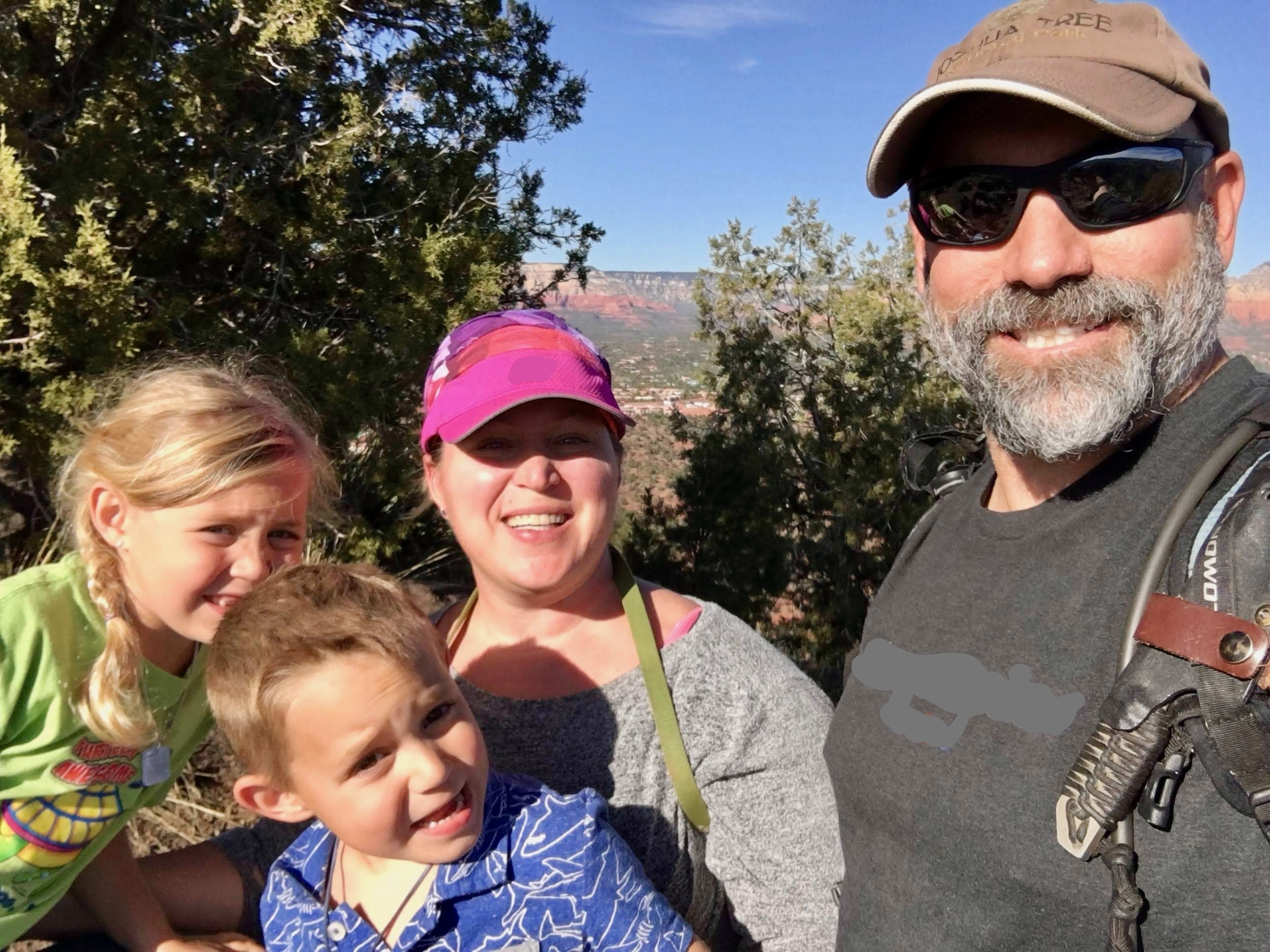 Scott and Traci with their children outdoors.